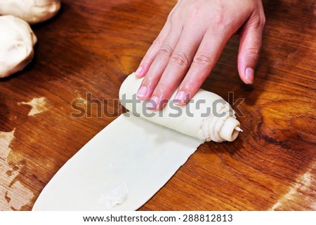 Woman hand making curry puff on wood