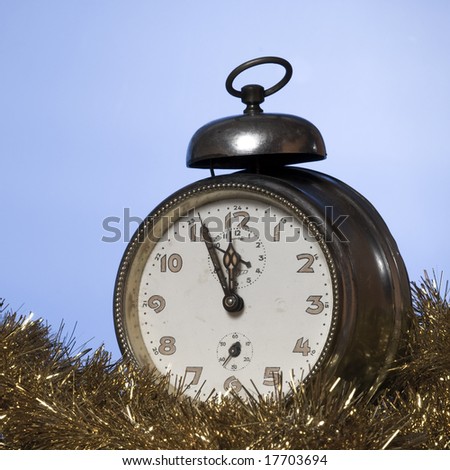 Old Alarm Clock showing few minutes to twelve
