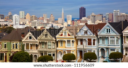 Famous Victorian row houses in San Francisco with skyline.  Houses referred to as the painted ladies