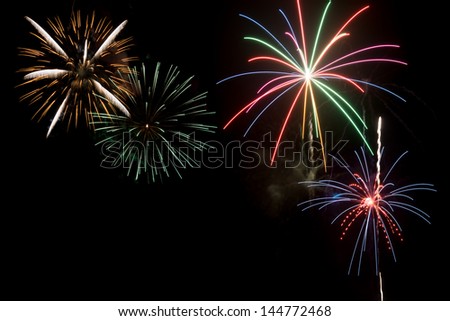 A group of fireworks exploding in night sky to celebrate Independence day in USA or July 4th holiday
