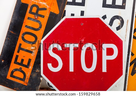 Detour sign, stop sign and road closed sign as a background
