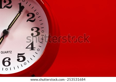 Red alarm clock on a red background with copy space