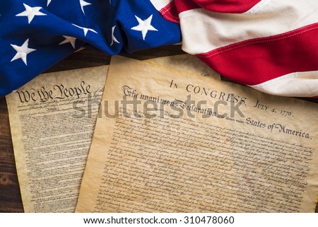 The Declaration of Independence and Constitution of the United States of America with a vintage flag