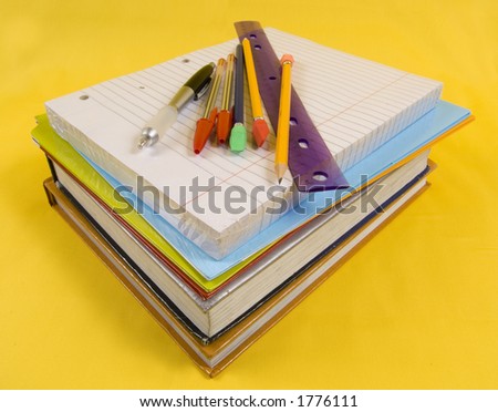 school supplies on yellow background with pen, pencils, rulers, paper and folders