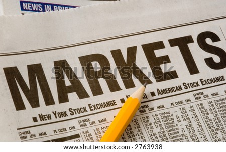 Newspaper open to market pages showing results.  Idea of studying the markets