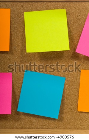 sticky notes or post-it notes on a cork board