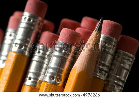 Macro shot of yellow pencils all erasers visible except one sharpened pencil, copy space to the left,