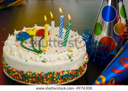 Decorated Birthday cake with candles and party hats