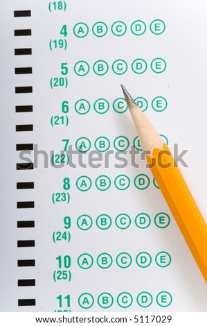 a yellow pencil lying on a multiple choice test or exam answer sheet