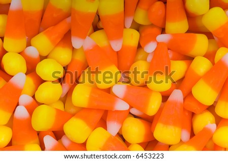 Background consisting of holiday or halloween candy corn with orange, yellow and white sectrions