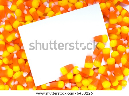 A blank notecard, invitation, or announcement with candy corn