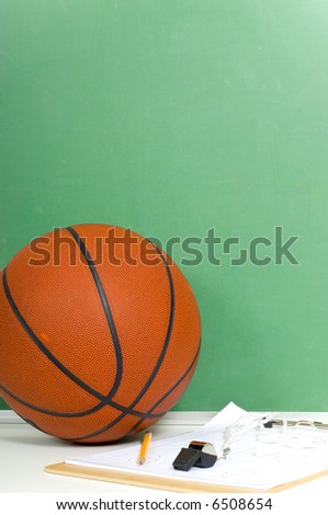 Items used by a basketball coach including a ball and a black board with copy space