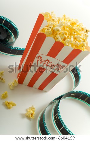 A box of popcorn with a stip of 35mm film on a white background, symbols of the entertainment industry