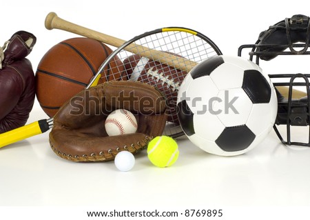 Variety of sports equipment on white background with copy space, items inlcude boxing gloves, a basketball, a soccer ball, a football, a baseball bat, a catcher\'s mitt or glove