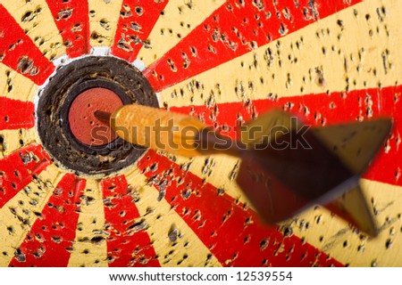 A game of darts with a dart in the bullseye of the dart board