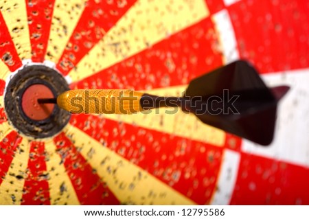 A game of darts with a dart in the bullseye of the dart board
