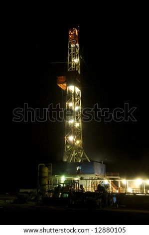 An oil drill or rig drilling at night. energy