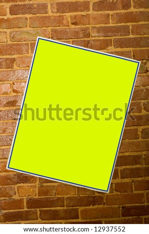 Blank concert or promotion poster on a brick wall, with clipping path for yellow area so you can change color or insert image or copy
