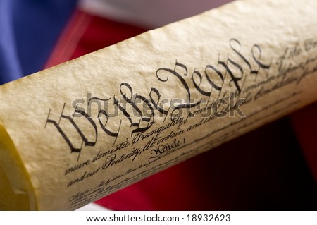 A copy of the United States Constitution on an American Flag Background