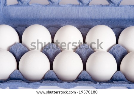 A blue carton of white farm fresh eggs