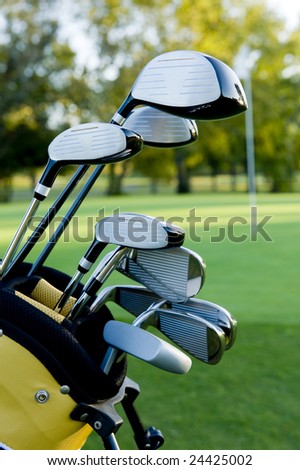 A set of golf clubs on a golf course on a beautiful sunny day