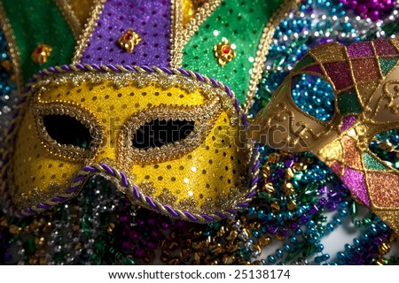 A group of Mardi Gras beads and  mask with copy space