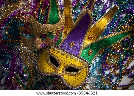 A group of mardi gras beads and mask with copy space