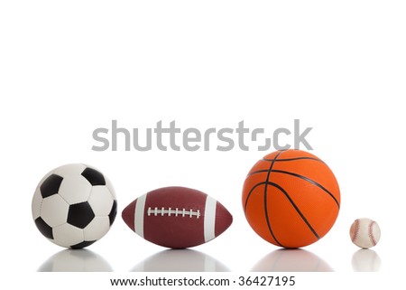 Assorted sports ball on a white background.  Includes a soccer ball, a football, a basketball and a baseball