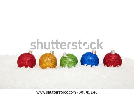 Assorted colored Christmas ornaments on a white background