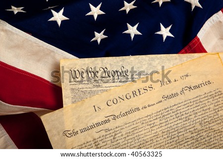United States\' Constitution and Declaration of Independence on a flag background