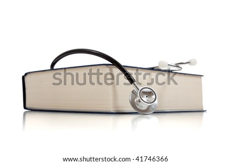 A medical reference book with a stethoscope on a white background