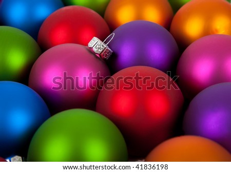 Multi-colored Christmas ornaments/baubles including pink, red, orange, blue, purple and green as a background