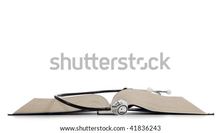 A medical reference book with a stethoscope on a white background