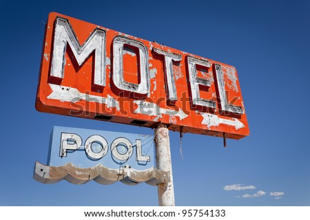 Red, vintage, neon motel sign on historic route 66 in front of blue sky