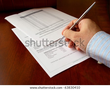 male hand with pen on the budget document