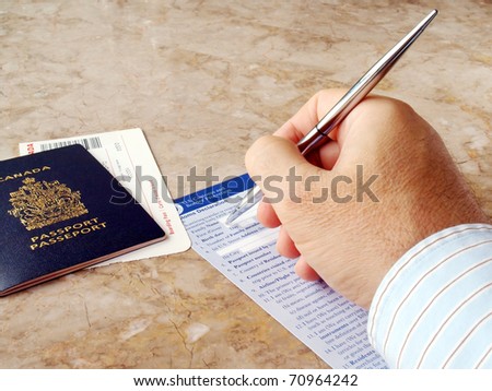 Man filling out U.S. customs and border form with Canadian Passport