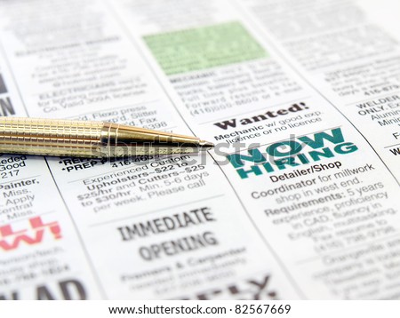 Pen on the newspaper career opportunity ad.