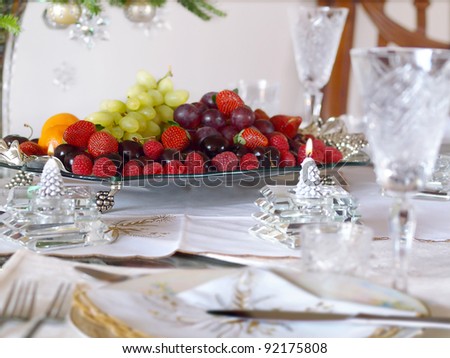 Holiday place setting with fruit tray and candles