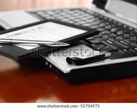 Home office with laptop, pen, phone and USB stick