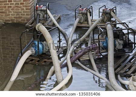 Industrial water pumps in pumping advancing floods.