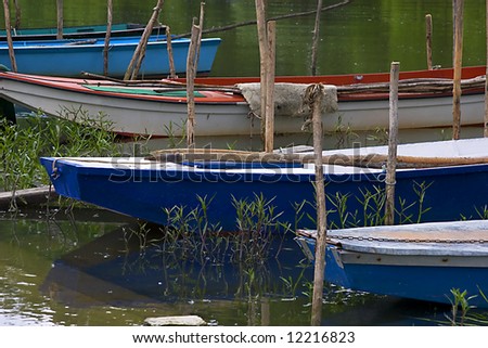 A colorful row of river fishing boats.