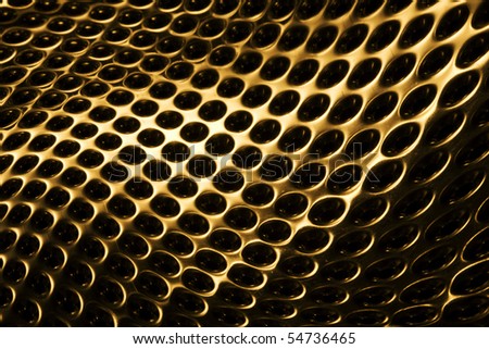 Curved gold metal background with perforated holes.