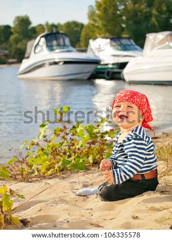 Little boy dressed up as a sailor on the riverside