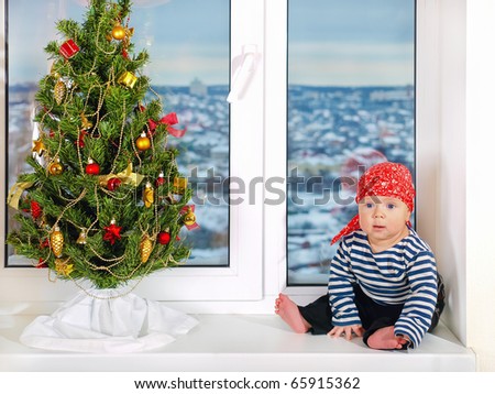 Six month cute baby boy dressed up in pirate costume for Christmas