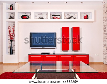 Beige and red interior of modern house with flat TV set