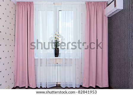 Interior view of window with curtains in bedroom