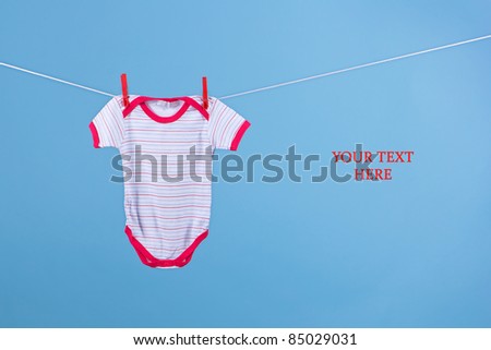 Baby suit hanging on the clothesline (with space for your text)