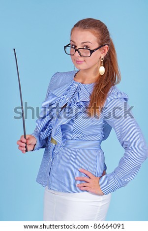 Young beautiful teacher in blue blouse wearing glasses standing and holding pointer