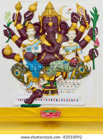 Indian God Ganesha or Hindu God Name Maha Ganapati avatar image in stucco low relief technique with vivid color,Wat Samarn temple,Thailand.
