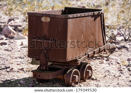 Old rusty mining ore cart in the desert